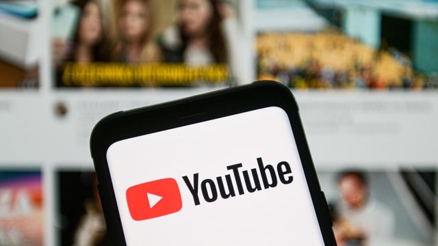 In this photo illustration a YouTube logo seen displayed on 
