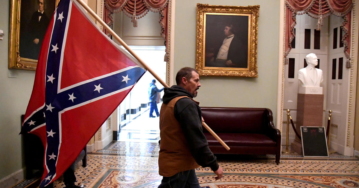 Man seen holding Confederate flag inside U.S. Capitol during riot arrested