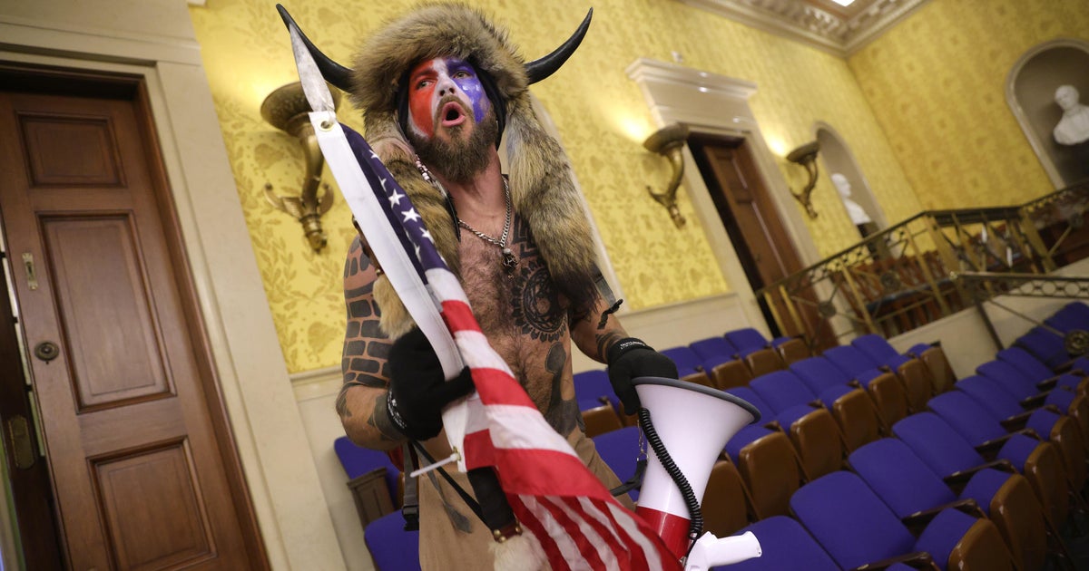 Capitol Rioter Jake Angeli Known As Qanon Shaman Will Be Jailed Until Trial Cbs News