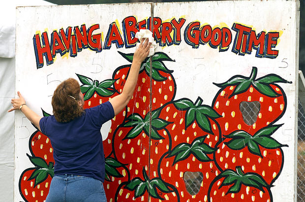 Wendy Springer cleans board used for the strawberry tart toss contest held during the California Str 