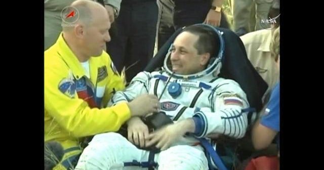Astronauts return to Earth after monthlong delay