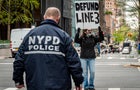 NYPD officer seen approaching a participant blocking a 