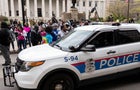Columbus Police cruisers round the Ohio Statehouse interact 
