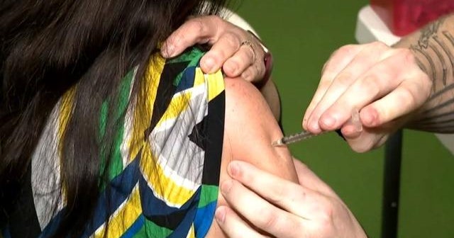 COVID-19 vaccine hesitancy concerns, warnings about new variants