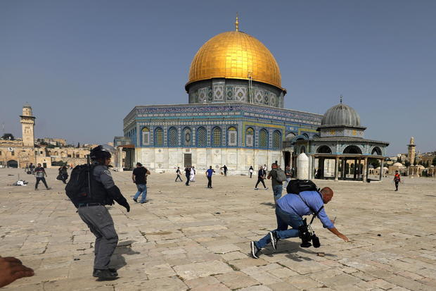 Israeli police clash with Palestinians at the compound that houses Al-Aqsa Mosque in Jerusalem 