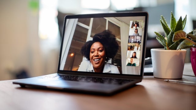 Businesswoman having a video call meeting with her team 