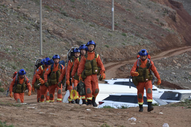 In this photo provided by China's Xinhua News Agency, rescuers walk into the accident site to search for survivors in Jingtai County of Baiyin City, northwest China's Gansu Province, Sunday, May 23, 2021. FAN PEISHEN / AP