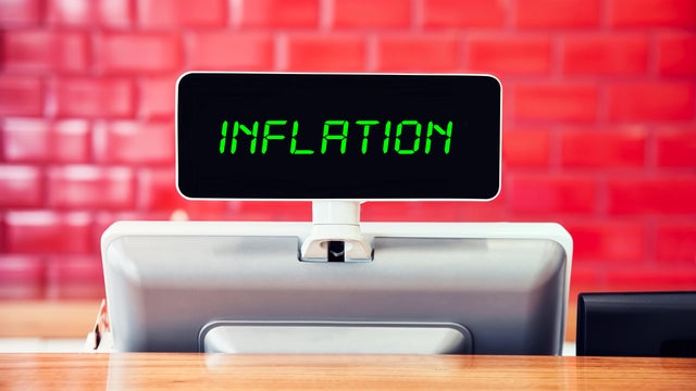 Digital cash register in a shop writing inflation on the screen 