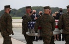 U.S. President Joe Biden salutes during the dignified transfer of the remains of U.S. Military service members who were killed by a suicide bombing at the Hamid Karzai International Airport 