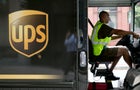 UPS truck side view with driver at the wheel 