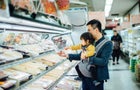 Couple buying fresh meat in supermarket. 