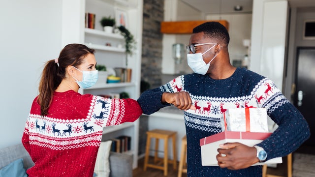 Young Caucasian woman welcoming her African American friend to her home