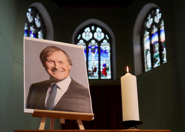 A candle and a portrait of British MP David Amess are seen at the church of St Michael's and all Angels, in Leigh-on-Sea 