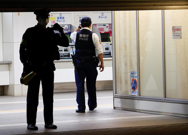 A police officer walks into the Kokuryo station of the Keio Line train where a knife, arson and acid attack incident occurred on a train, in Tokyo 