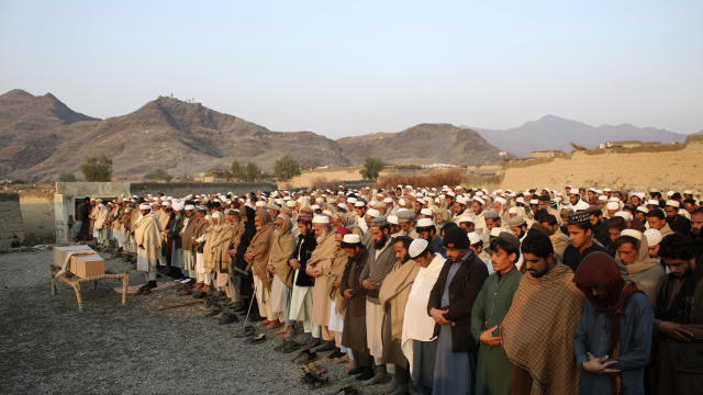 People pray during the funeral for a victim of an explosion in eastern Afghanistan near the border with Pakistan that killed nine children and wounded four, according to the office of a Taliban-appointed governor, in Jalalabad, Afghanistan, January 10, 20 