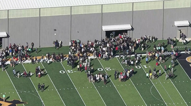 Evacuated students on Crandall High football field 