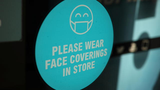Signage showing health information is seen on the window of a shop in the town centre, amid the coronavirus disease (COVID-19) outbreak in Bolton, Britain 