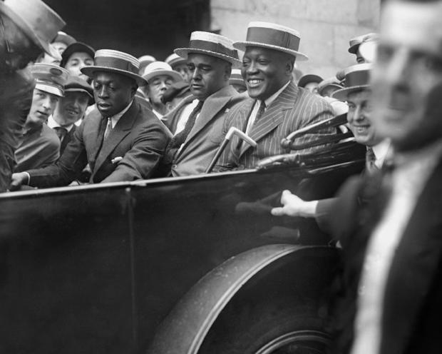 Jack Johnson rides in a parade 