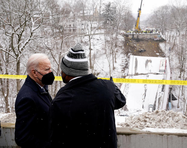 President Biden listens to Pittsburgh Mayor Ed Gainey as they visit the site of a bridge collapse in Pittsburgh, Pennsylvania, January 28, 2022. 