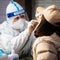 China locks down city of 9 million as COVID cases spike