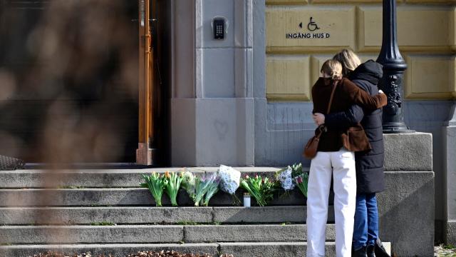 People mourn outside Malmo Latin School the day after two women died, in Malmo 