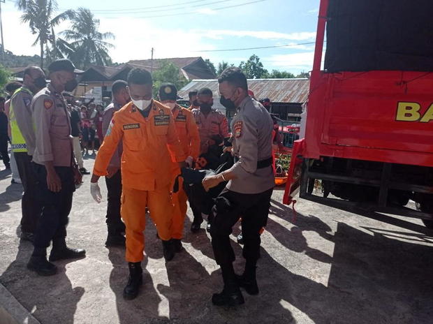 National Search and Rescue officers carry a body bag after a truck accident in Manokwari 