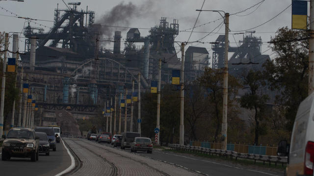 Cars drive by an Azov Stal steel plant avenue in in Mariupol 