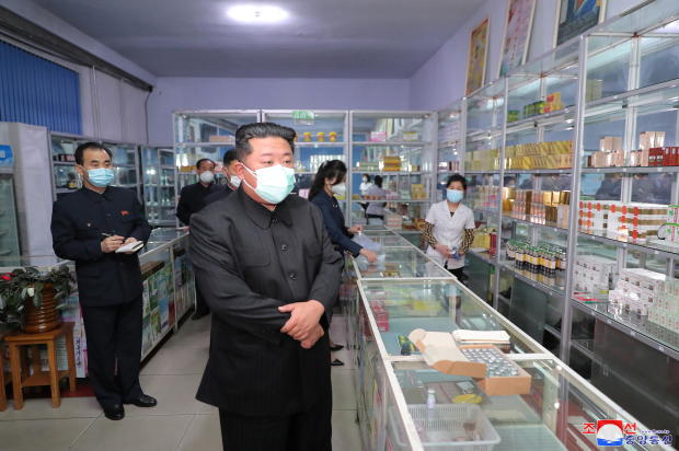 North Korean leader Kim Jong Un wears a face mask amid the coronavirus disease (COVID-19) outbreak, while inspecting a pharmacy in Pyongyang 