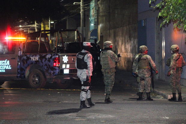 Security forces guard the scene where gunmen attacked bars and killed people, in Celaya 